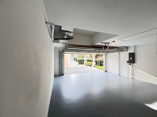 garage featuring a garage door opener and electric panel