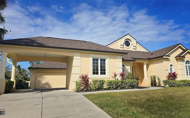 view of front of property with a front lawn, a carport, and a garage