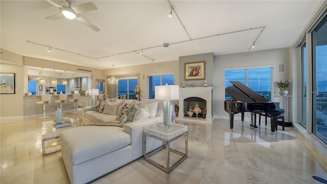 living room with ceiling fan with notable chandelier