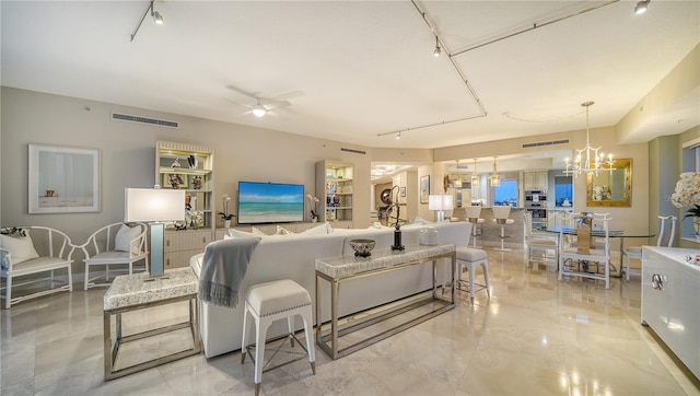 living room with ceiling fan with notable chandelier