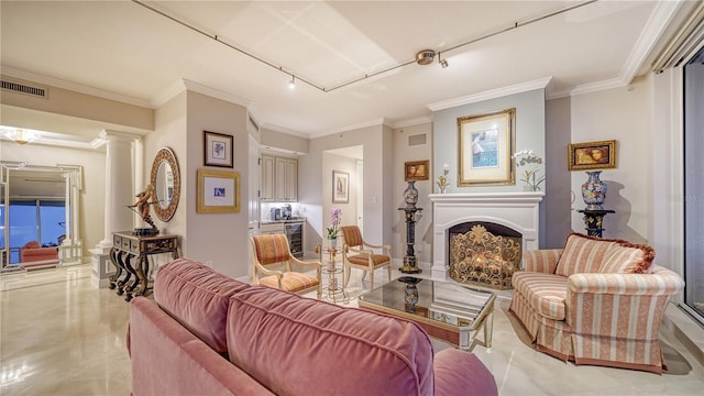 living room with ornamental molding, track lighting, and ornate columns