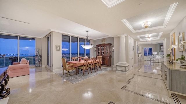 dining room featuring floor to ceiling windows, a tray ceiling, and ornate columns