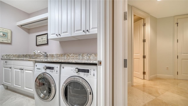 clothes washing area with sink, light tile patterned floors, cabinets, and independent washer and dryer