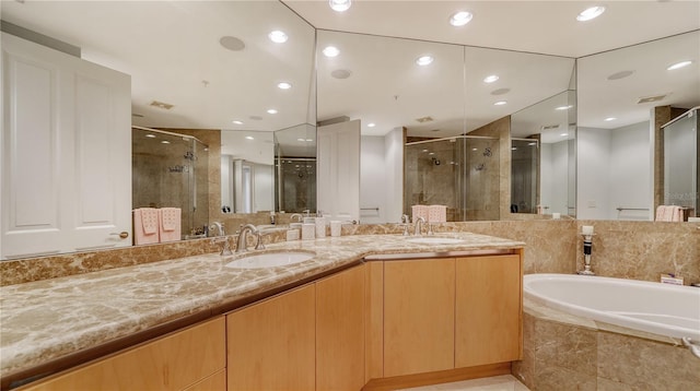 bathroom featuring vanity and shower with separate bathtub