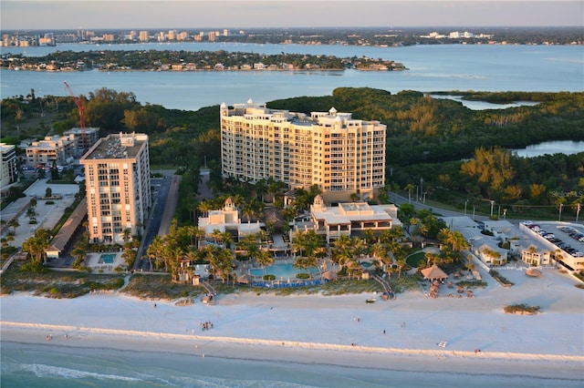 bird's eye view featuring a water view and a beach view