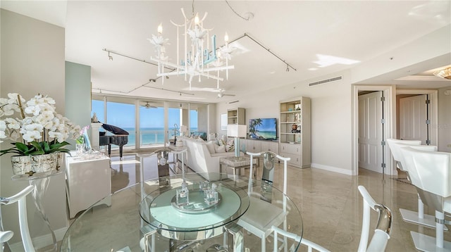 dining area featuring expansive windows and an inviting chandelier