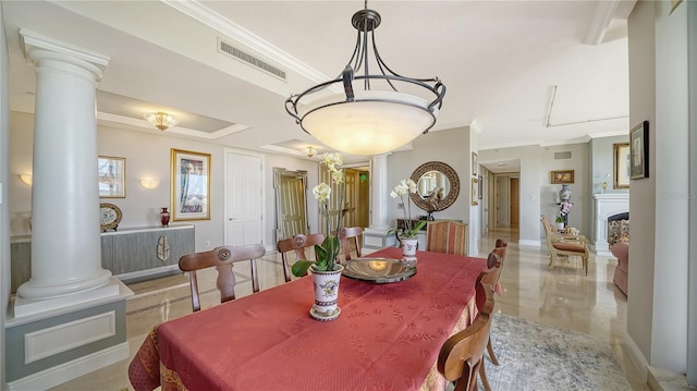 dining room with ornamental molding and ornate columns