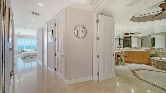 hall featuring an inviting chandelier