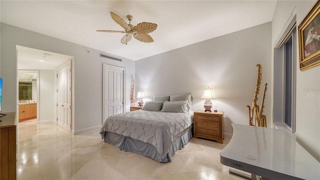 bedroom featuring ceiling fan, a closet, and ensuite bath