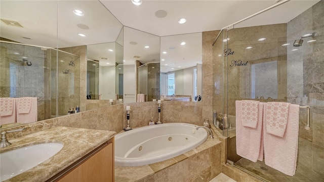 bathroom with vanity and shower with separate bathtub