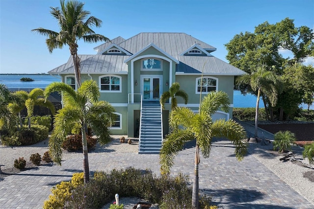 view of front of house featuring a water view and french doors