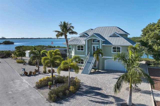 view of front of property featuring a water view and a garage