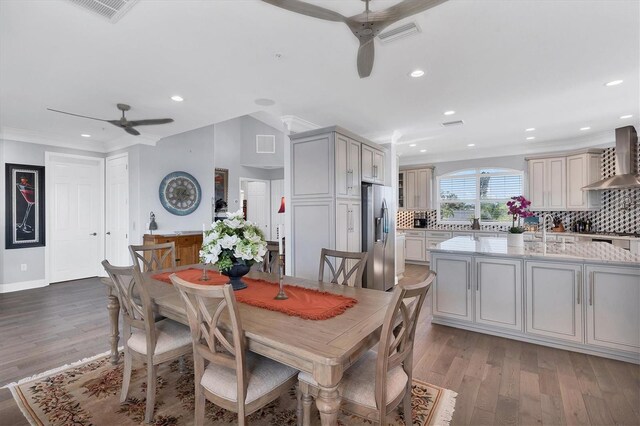 dining area with crown molding, sink, ceiling fan, and light hardwood / wood-style flooring