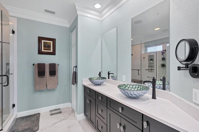 bathroom with ornamental molding, vanity, and a shower with shower door