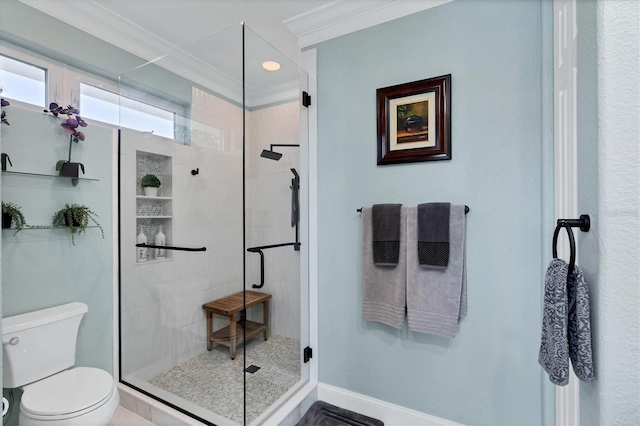 bathroom featuring an enclosed shower, crown molding, and toilet