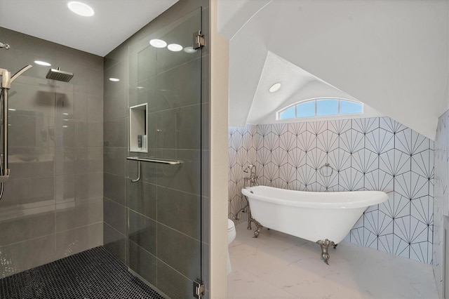 bathroom featuring shower with separate bathtub, lofted ceiling, tile walls, and toilet