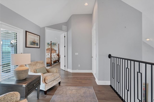 sitting room featuring lofted ceiling and dark wood-type flooring