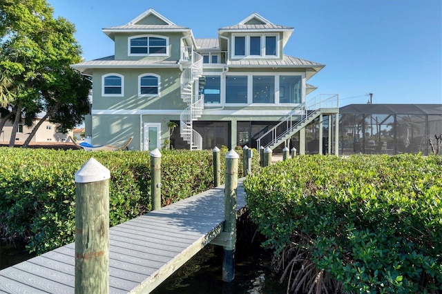 rear view of property featuring a sunroom