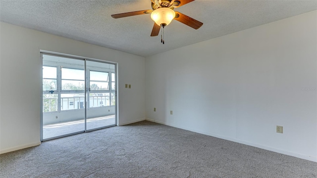 carpeted empty room with ceiling fan and a textured ceiling