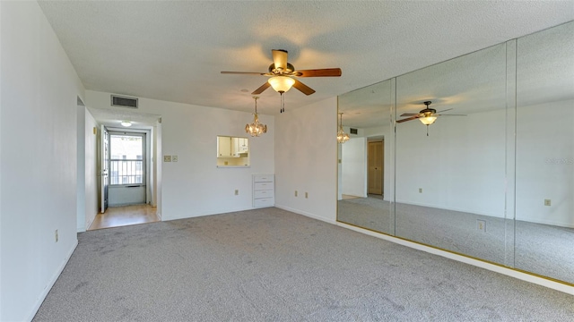 spare room with ceiling fan, carpet flooring, and a textured ceiling