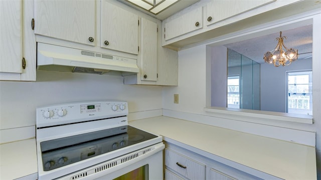 kitchen with decorative light fixtures, a notable chandelier, and electric stove