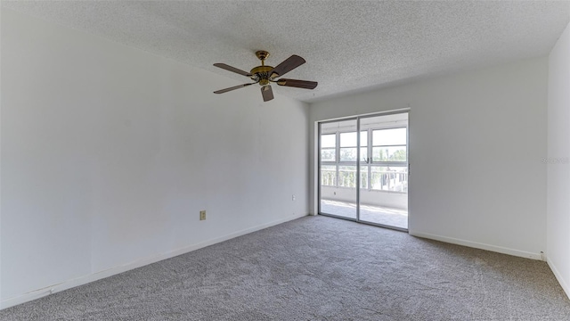 carpeted spare room with ceiling fan and a textured ceiling