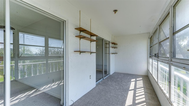 unfurnished sunroom with a wealth of natural light