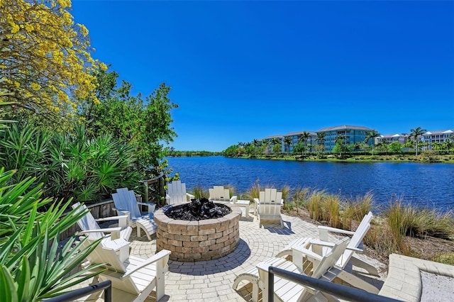 view of patio / terrace featuring a water view and a fire pit