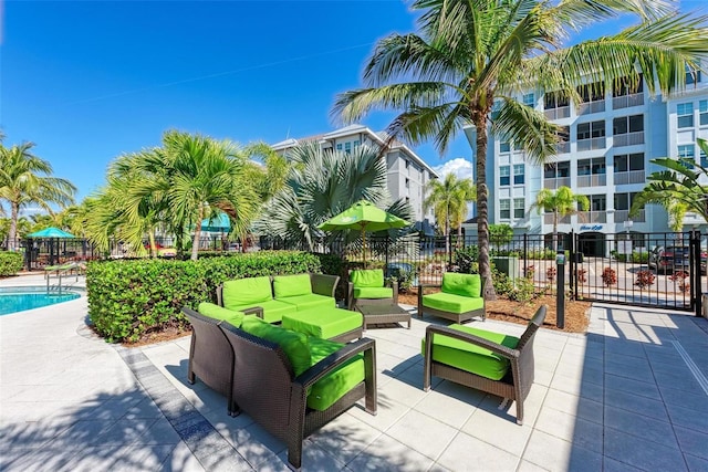 view of property's community with a patio area, outdoor lounge area, and a pool