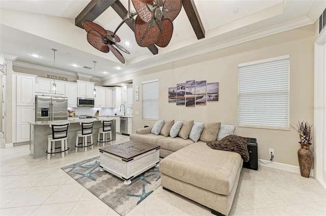 living room with ceiling fan, light tile patterned floors, sink, and beamed ceiling