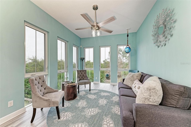 living room with light wood-type flooring and ceiling fan