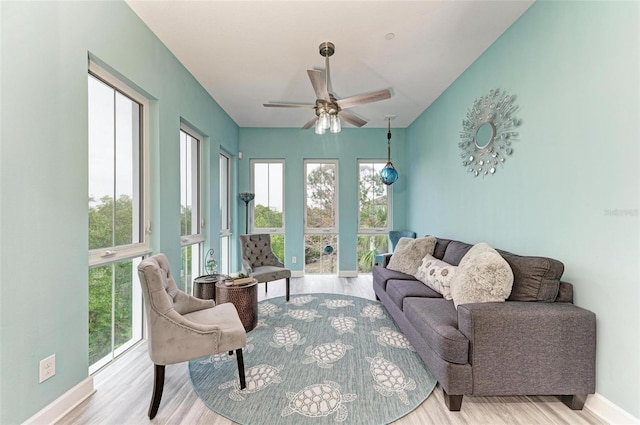 interior space with ceiling fan, a wealth of natural light, and light hardwood / wood-style flooring