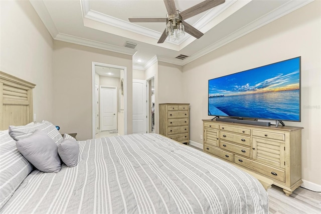 bedroom featuring ceiling fan, crown molding, and light wood-type flooring