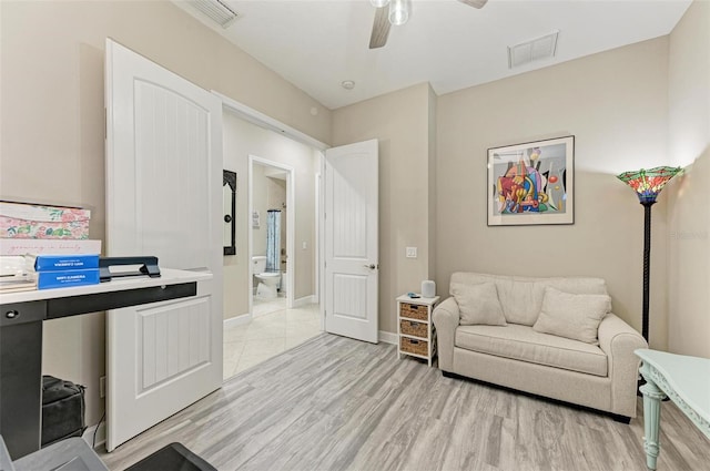 sitting room featuring ceiling fan and light hardwood / wood-style floors