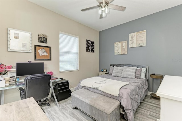 bedroom with ceiling fan and light hardwood / wood-style floors