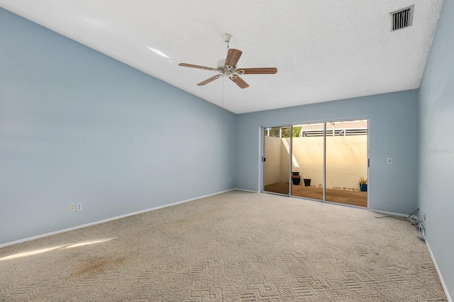 carpeted spare room with a textured ceiling, ceiling fan, and lofted ceiling