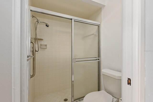 bathroom with toilet and walk in shower