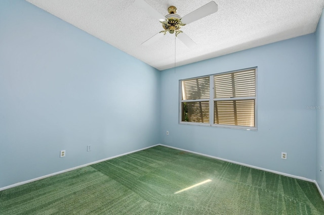 empty room with carpet flooring, ceiling fan, and a textured ceiling