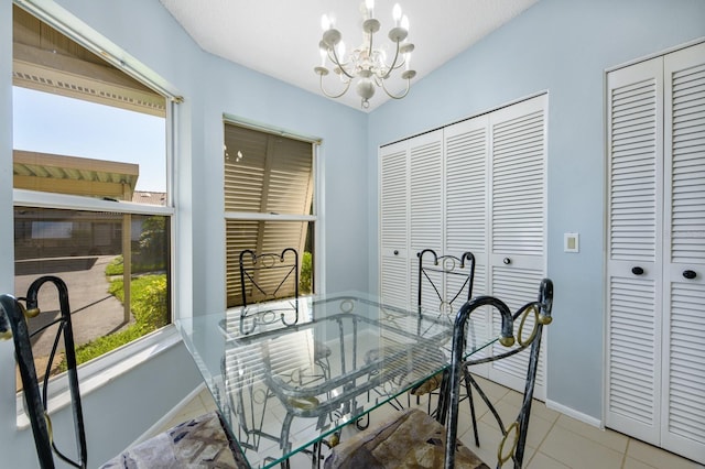 dining area featuring a notable chandelier and light tile patterned floors