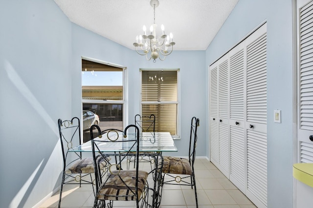 tiled dining area with a textured ceiling and an inviting chandelier