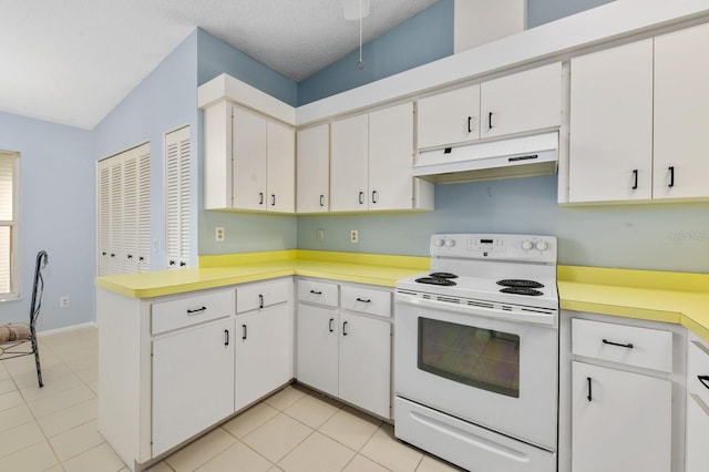 kitchen with a textured ceiling, white range with electric cooktop, white cabinets, and lofted ceiling