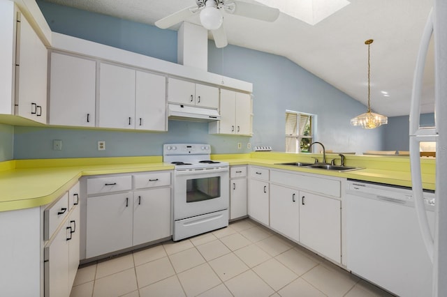 kitchen featuring white appliances, white cabinetry, and hanging light fixtures