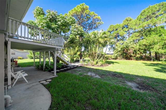 view of yard with a patio and a wooden deck