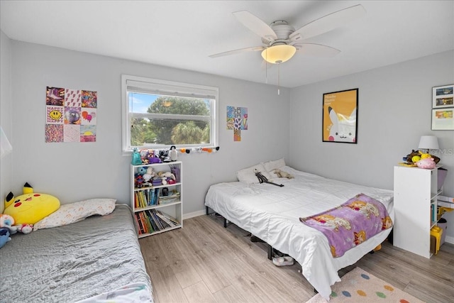 bedroom with light hardwood / wood-style floors and ceiling fan