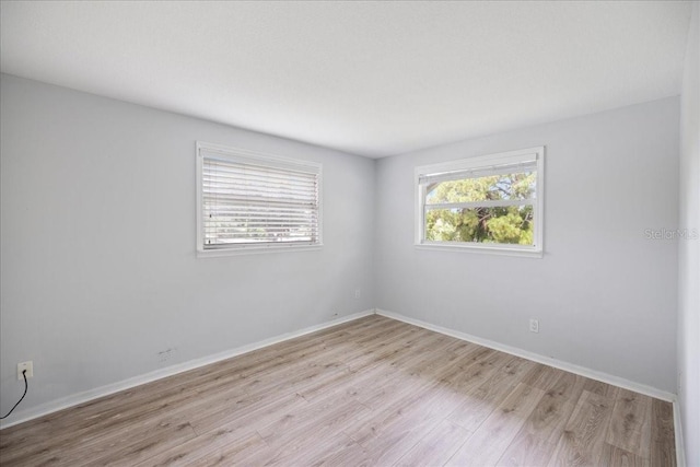 empty room with light hardwood / wood-style flooring