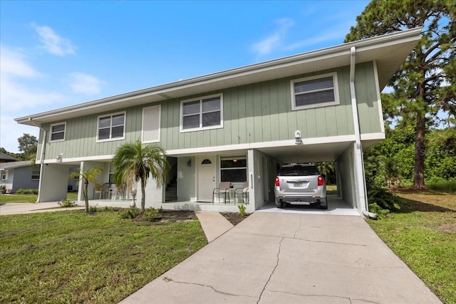 view of front of home featuring a porch, a front lawn, and a carport