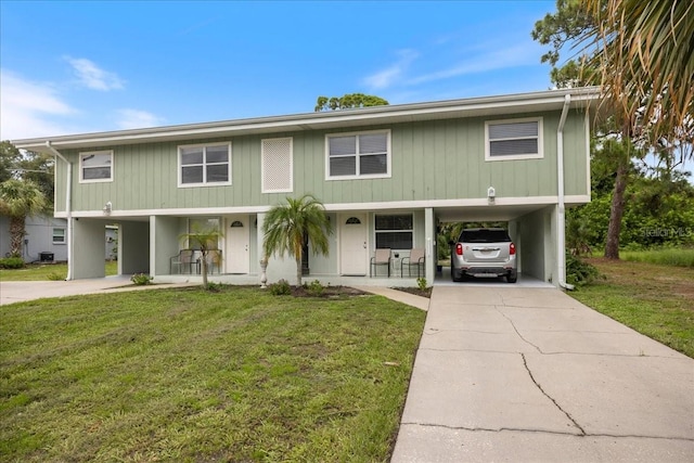 view of front of home with a front lawn and a carport