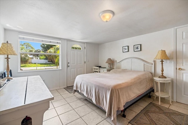 bedroom featuring a textured ceiling and light tile patterned floors