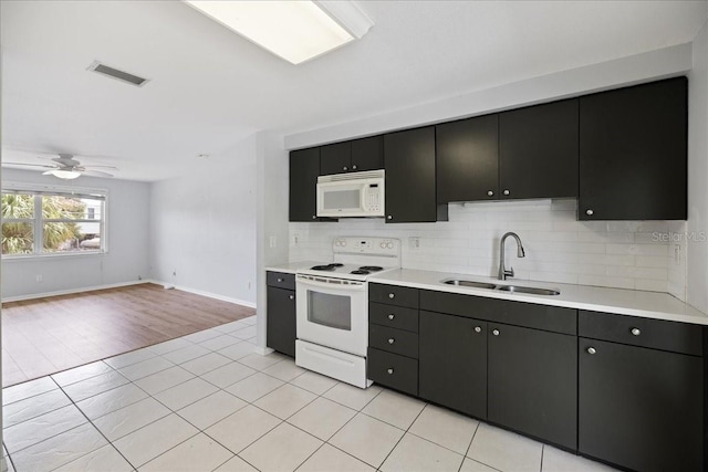 kitchen featuring tasteful backsplash, ceiling fan, light hardwood / wood-style floors, sink, and white appliances