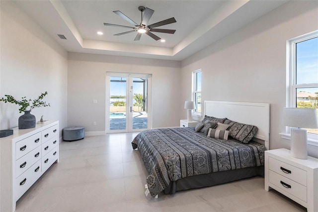 bedroom with recessed lighting, visible vents, access to exterior, french doors, and a raised ceiling